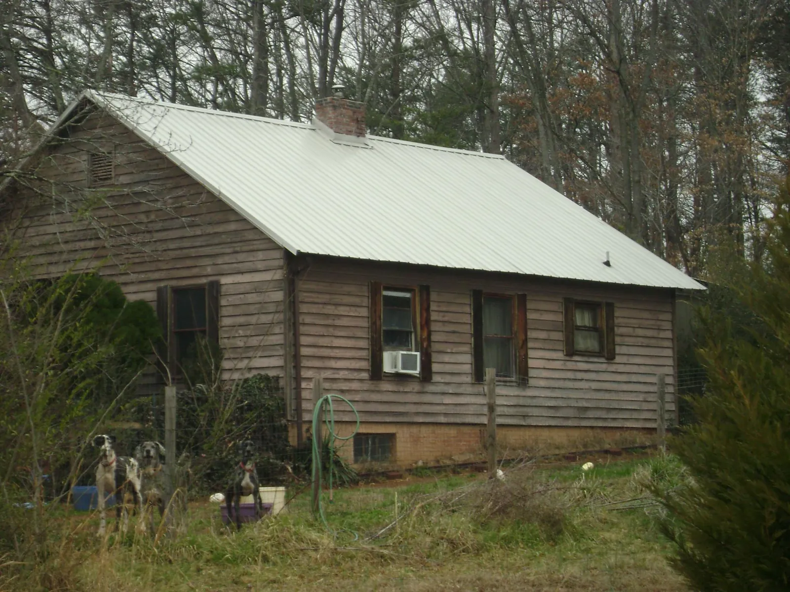 White metal roof on an old wood sided farmhouse, from a Metal Roof Installation job in Windham